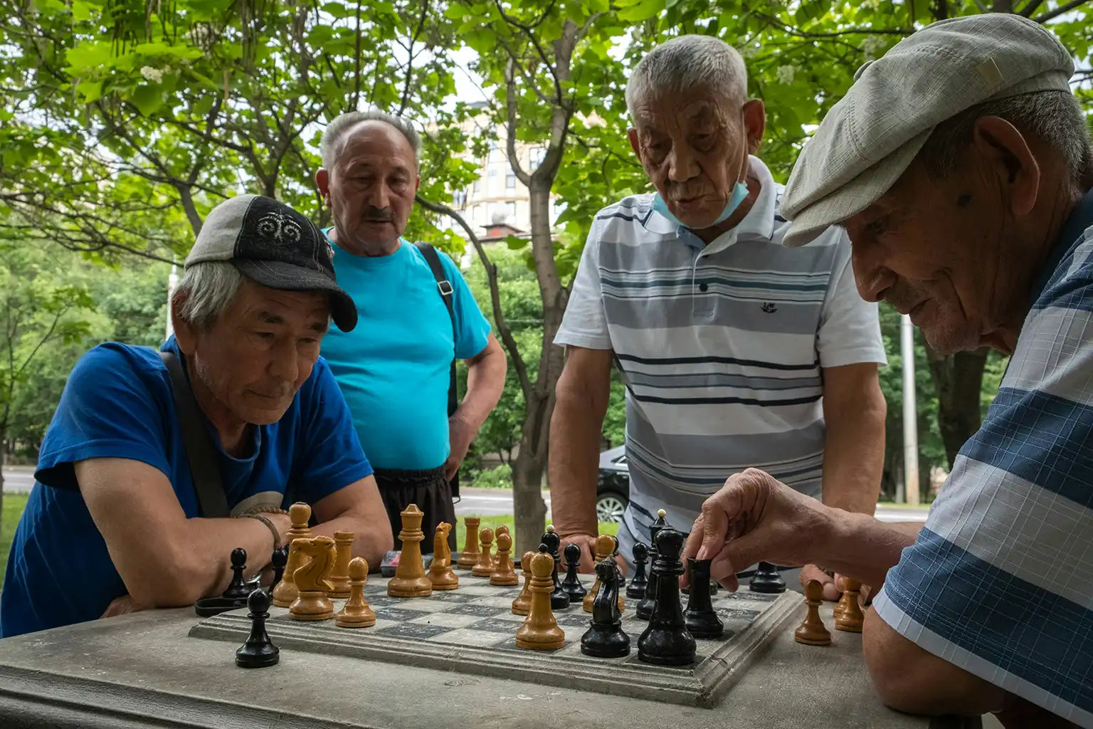 Older men playing chess in the park